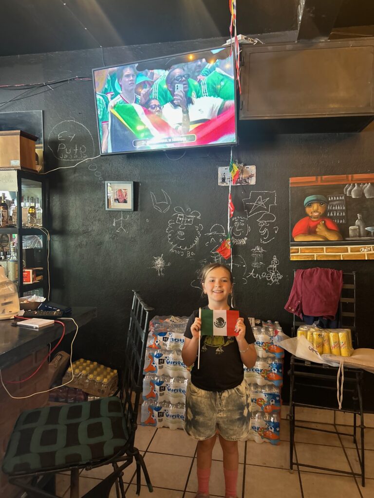 kid holding flag in bar